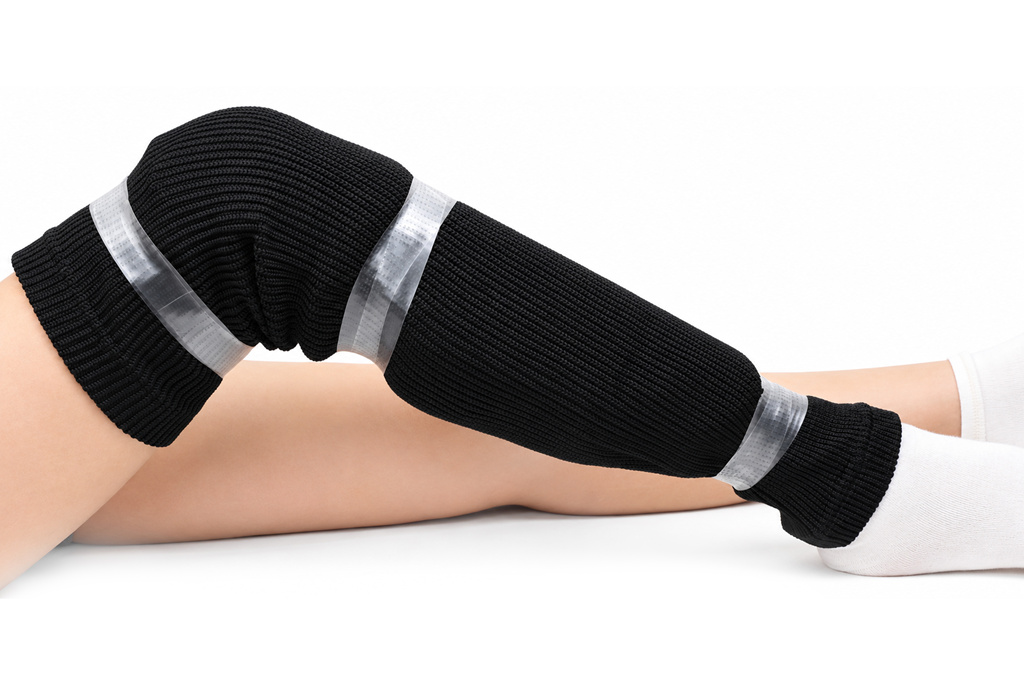Clear hockey tape securing a hockey sock and shin guard in place
