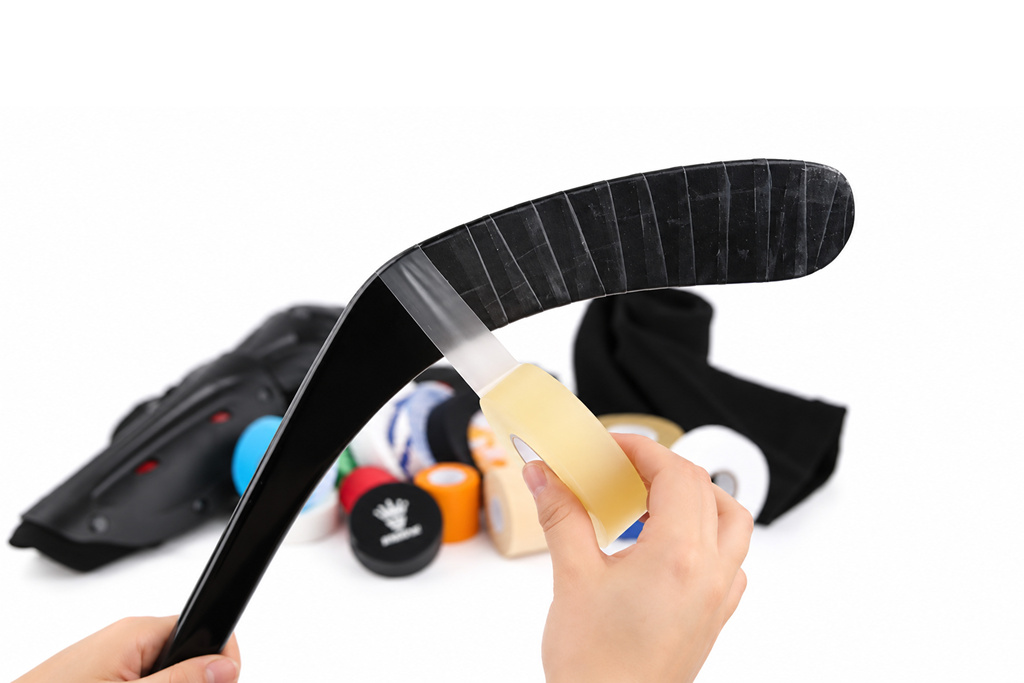 Clear hockey tape wrapped around a hockey blade for added protection