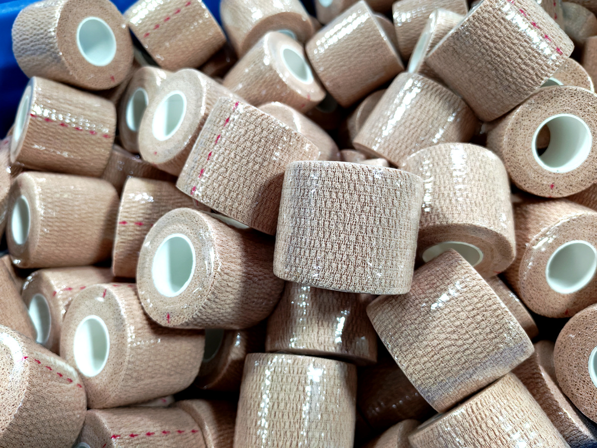 {"default":"Finished cohesive bandage cartons stacked in warehouse ready for shipment"}
