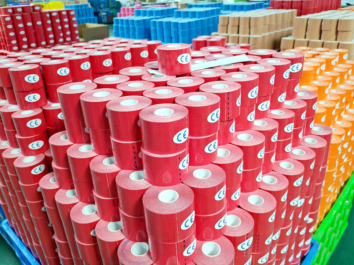 Rolls of finished kinesiology tape stacked in the factory