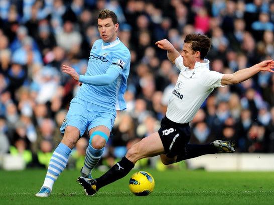 football player use kinesiology tape on knee during football match 