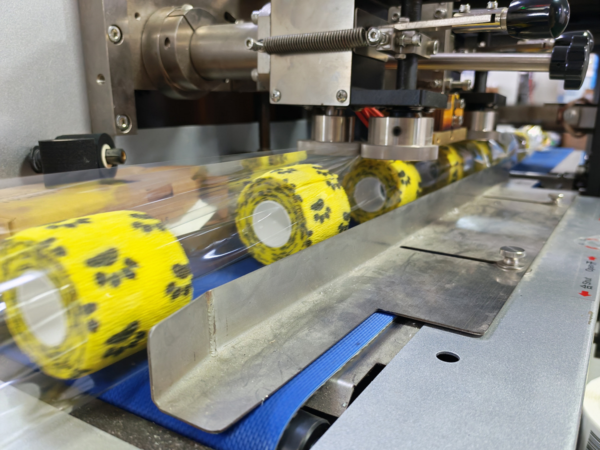 {"default":"yellow printed vet wrap with black cat paw are packing"}
